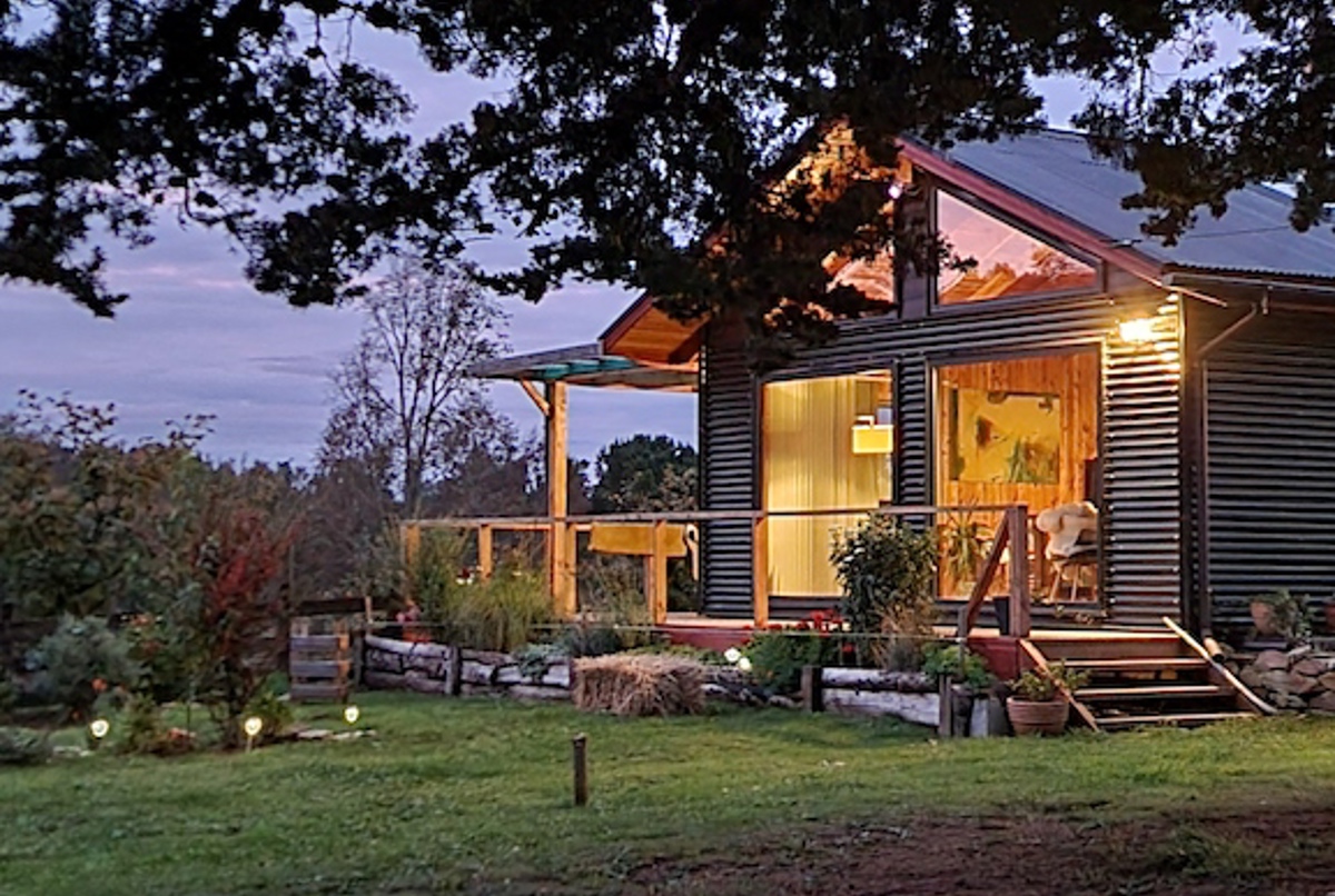 A remote home set in a tranquil forest landscape