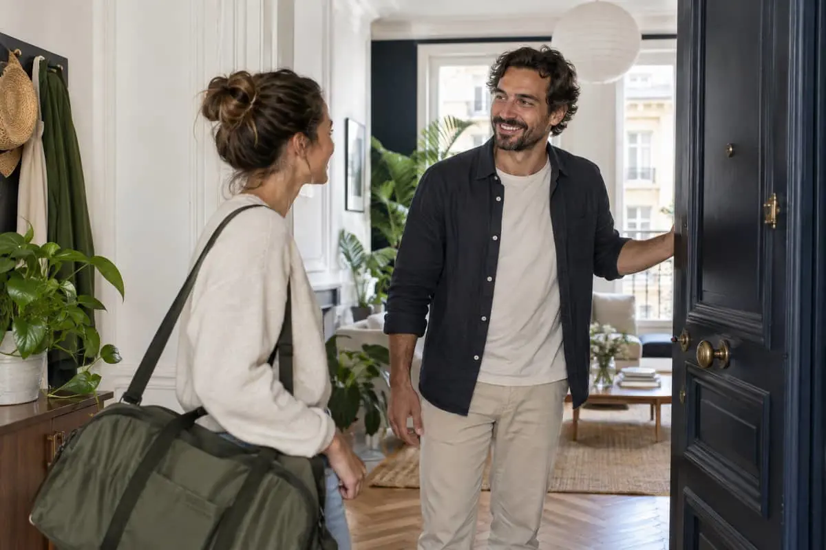 Two people meeting at the entrance to a home